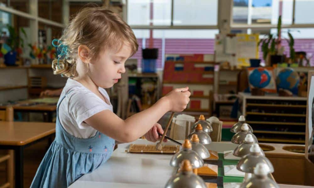 Forestville Montessori preschool child using bells